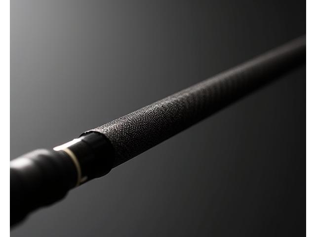 Sleek fishing rod made from dark, recycled carbon fiber, highlighting its texture and strength.